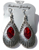 Boucles d'oreilles pendantes en metal argente cisele serties de pierres rouge
