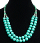 Collier ethnique artisanal deux rangs imitation pierres rondes turquoises agencees de perles vertes et argentees