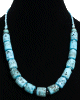 Collier ethnique artisanal imitation corail bleu claire agremente de perles bleues et en metal