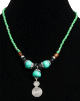 Collier ethnique artisanal perles bleues vertes avec boules imitation turquoise, agrémenté de pièces argentées et d'un grand pendentif tourbillon en métal argenté Collier ethnique artisanal perles bleues vertes avec boules imitation turquoise, agremente de pieces argentees et d'un grand pendentif tourbillon en metal argente